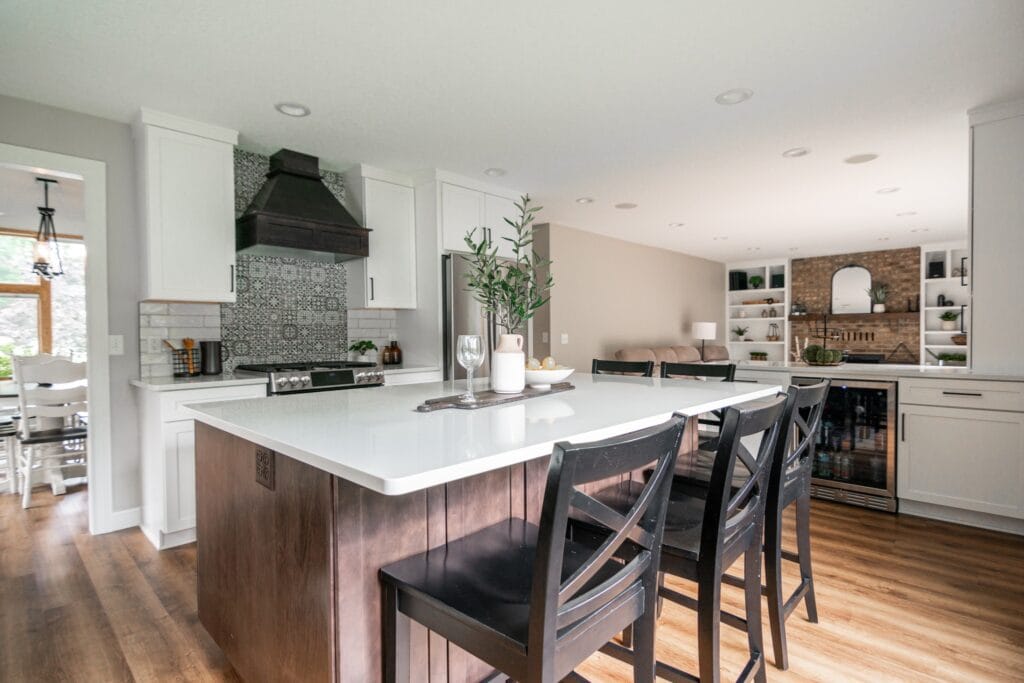 Kitchen with an oven hood with angle in the corner of the room with chair in front of them