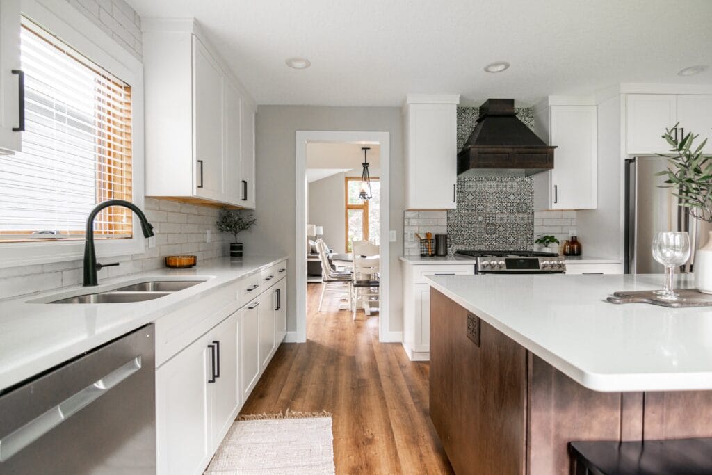 Kitchen with oven hood and white quartz countertops
